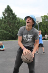 Boy in Live Generously t-shirt with basketball